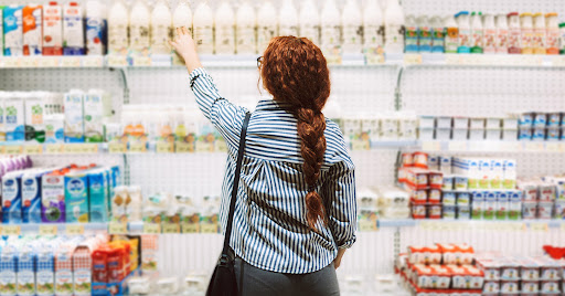 Customer in supermarket buying dairy